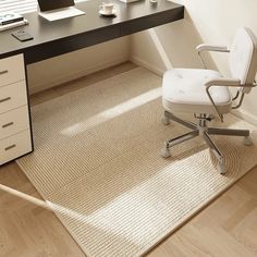 an office chair sitting in front of a desk with a laptop computer on top of it