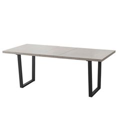 the table is made from concrete and has black metal legs, with a rectangular top