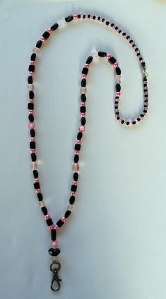 Pretty Pink and  Black glass lanyard is a stylish way to display your ID Badge! Lanyard is made using various styles of pink and black glass beads and has a coordinating gunmetal  swivel hook. Measures 17.5" from center of neck to end of hook. Custom orders are welcome. Adjustable Pink Beaded Necklaces With Black Beads, Adjustable Pink And Black Beaded Necklaces, Adjustable Pink Beaded Necklace With Black Beads, Bamboo Roots, Swivel Hook, Badge Lanyard, Id Badge Holders, Leaf Nature, Badge Holder