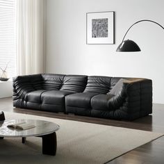 a modern living room with black leather furniture