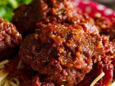 spaghetti and meatballs on a plate with garnishes