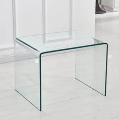 a glass table sitting on top of a white floor