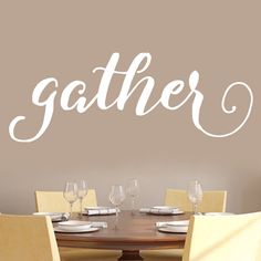 a dining room wall decal with the word gather written in cursive font