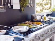 a stove top with various cooking utensils sitting on it's burners