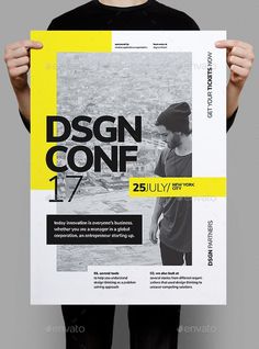 a person holding up a poster with the words design conf on it