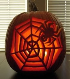 a pumpkin carved to look like a spider web