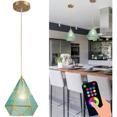 a person holding a remote control in front of a kitchen with an island and pendant light