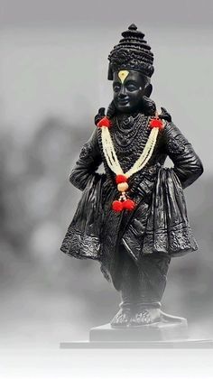 an image of a statue with beads on it