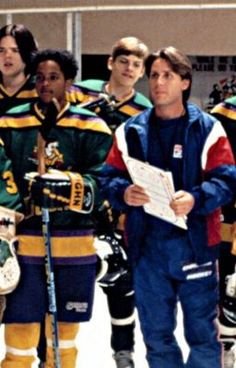 the hockey team is lined up on the ice with their coach in blue and yellow