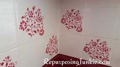 a bathroom with red and white tiles on the wall