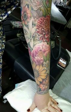 a woman's arm with flowers on it