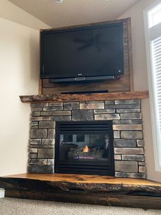 a flat screen tv mounted above a fireplace