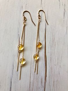 Tiny sparkly citrine coins dangle on a gold filled chain and ear hook. Stone size 5-6mm Length 3 inches MATERIAL: GOLD-FILLED - 14k Gold filled is considerably durable and considered a lifetime piece of jewelry. This is NOT gold plated or gold dipped vermeil jewelry which can chip off over time with wear. Gold filled metal is essentially a 14k gold tube filled with an inner core metal such as brass and has been mechanically bonded with high very hot heat. It will never chip or flake off such as Handmade Gold Long Drop Crystal Earrings, Gold Long Drop Crystal Earrings For Jewelry Making, Gold Citrine Drop Jewelry, Nickel-free Citrine Dangle Jewelry, Gold Long Drop Crystal Earrings Nickel Free, Gold Nickel-free Long Drop Crystal Earrings, Handmade Dainty Gold Crystal Earrings, Yellow Gold Citrine Dangle Earrings, Gold Citrine Wire Wrapped Jewelry