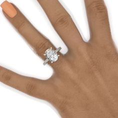 a woman's hand with an orange manicured nail polish and a diamond ring