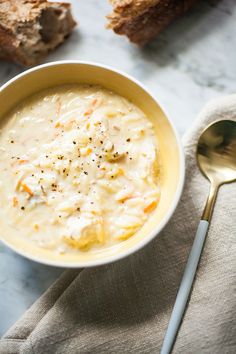 a bowl of soup with bread on the side