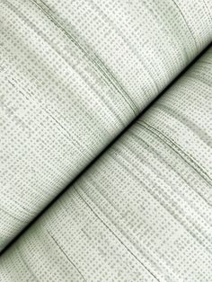 close up view of the texture of a white fabric with small dots and lines on it