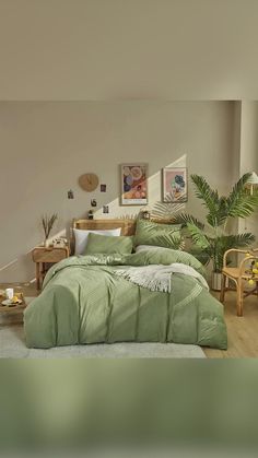 a bedroom with a bed covered in green comforter and pillows on top of it