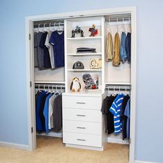 an open closet with clothes and toys on the shelves, in front of a blue wall