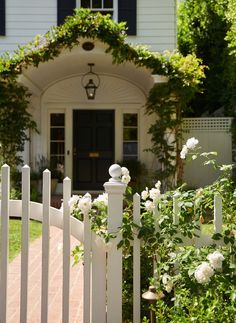 a white picket fence in front of a house