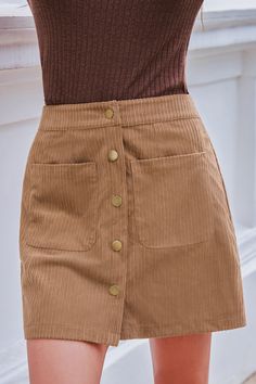 Add a touch of vintage charm with this Brown Front Button Pocket Mini Skirt. The playful pockets and warm color make it a versatile addition to your wardrobe, perfect for any casual outing. Product code: CAA02A4J001HH Features:  Woven Front buttons Pockets Mini Wash Method: Regular Wash Material: 100%POLYESTER. Fall High Waist Mini Skirt With Pockets, High Waist Mini Skirt With Pockets For Fall, High Waist Brown Skirt With Pockets, Trendy Winter Skirt With Pockets, Casual Button-up Fall Skirt, Retro Winter Skirt With Pockets, Retro High Waist Mini Skirt With Pockets, Beige High Waist Mini Skirt With Pockets, Beige High-waist Mini Skirt With Pockets