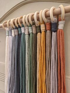 a row of different colored cords hanging on a wall