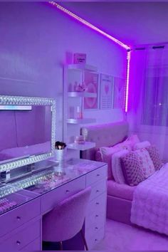 a bedroom with a bed, desk and mirror in the corner that has purple lights on it