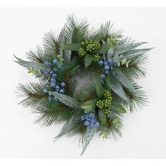 a wreath with blue berries and green leaves