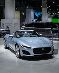 a silver sports car is on display at an auto show