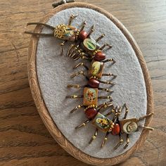 some kind of brooch sitting on top of a wooden table