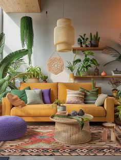 a living room filled with lots of plants next to a couch and coffee table on top of a rug