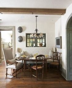 a dining room with wood floors and white walls