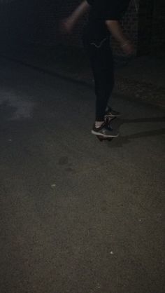 a person on a skateboard in the dark