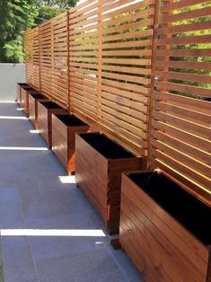 a row of wooden planters sitting next to each other