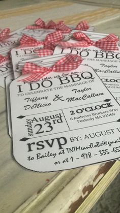 some tickets are sitting on top of a table with red and white bows around them