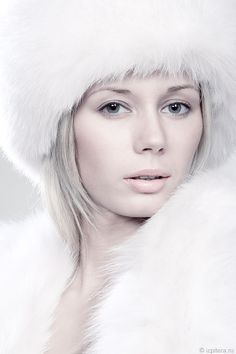 a woman wearing a white fur hat