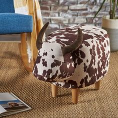 a cow foot stool sitting on top of a rug