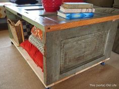 a coffee table with books on it and a basket sitting on top of the table