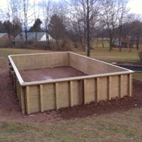 an empty pool in the middle of a field