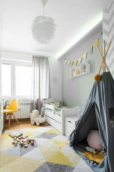 a child's bedroom with a teepee tent in the corner