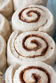 several cinnamon rolls are on a plate ready to be eaten