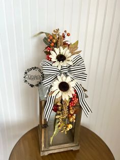 a vase filled with flowers on top of a wooden table