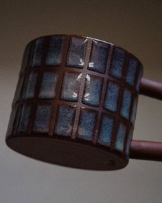 a close up of a brown and blue ceramic object on a light fixture in a room