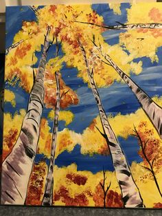 an acrylic painting of trees with yellow leaves and blue sky in the background