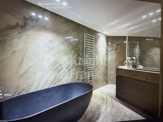 a bathroom with a blue bathtub next to a sink