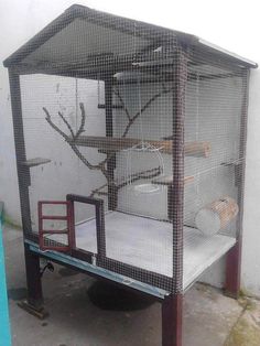 a bird cage that is sitting on top of a table