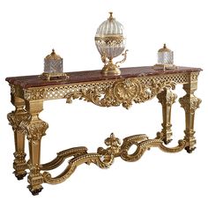 a golden console table with two lamps on top