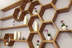 the shelves are made out of wooden hexagons and have flowers on them