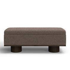 an upholstered footstool with two legs and a cushion on the top