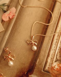 Add a touch of chic to your look with the Cosette Bow Necklace! This elegant accessory boasts a classic pearl bow to give your outfit a subtle yet captivating boost. It's the perfect way to subtly add a little pizzazz to your every day look!The Cosette Bow Necklace pairs well with matching earrings.  18kt gold plated silver bow and pearl the dangles. 22mm in length. Golf filled chain 16 or 18 inches. All items come in a gift box ready to gift. To see more please visit  https://www.etsy.com/shop/ Vintage French Wedding, Wedding Pearl Jewelry, Pearl Jewelry Gift, Pearl Birthstone, Evil Eye Necklace Gold, Latest Jewellery Trends, Pearl Bow, Bow Necklace, Bow Jewelry