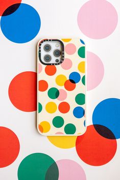 an iphone case is sitting on top of a colorful polka dot pattern wallpaper with multi - colored circles